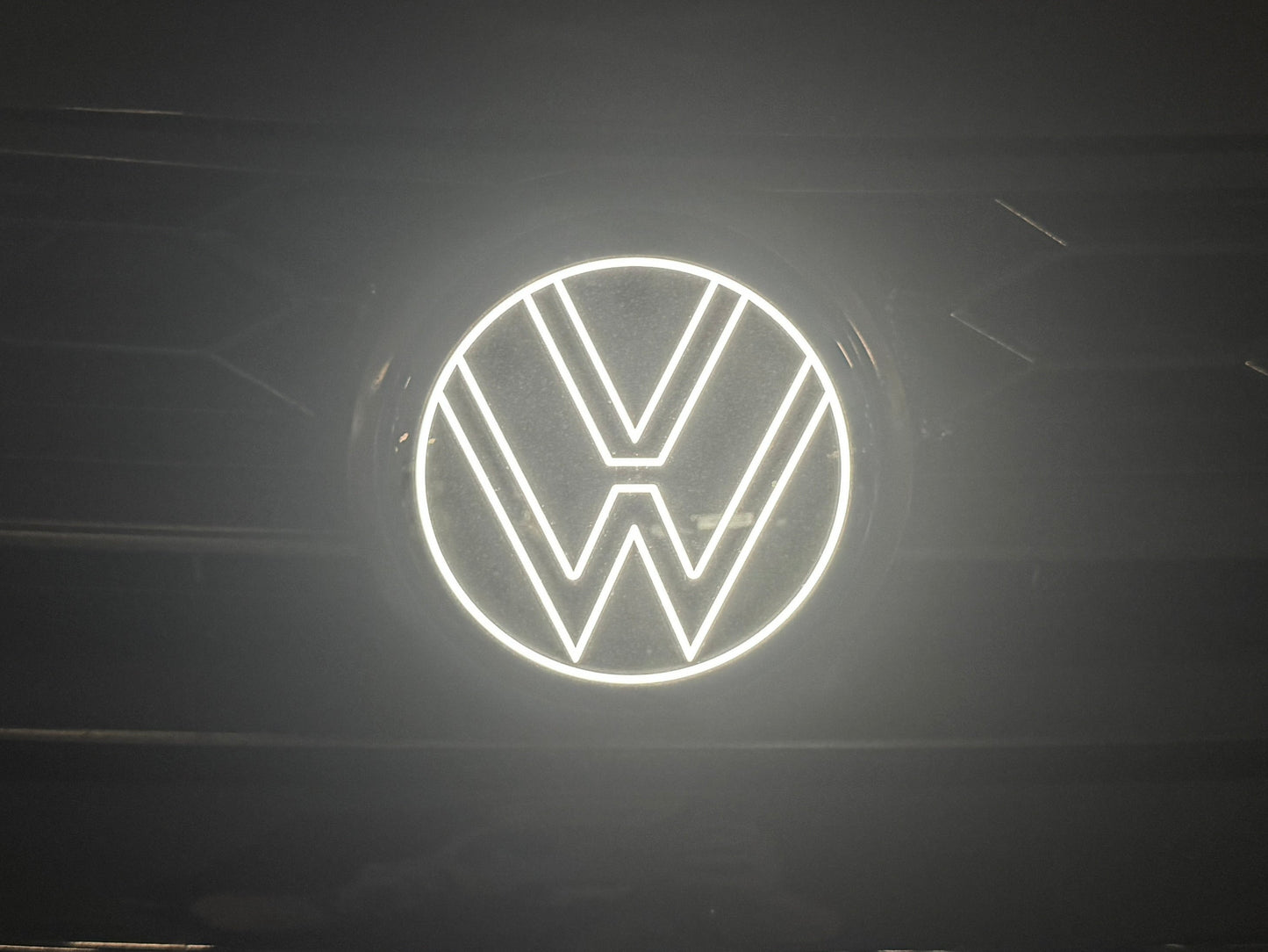 Volkswagen logo illuminated on a dark background