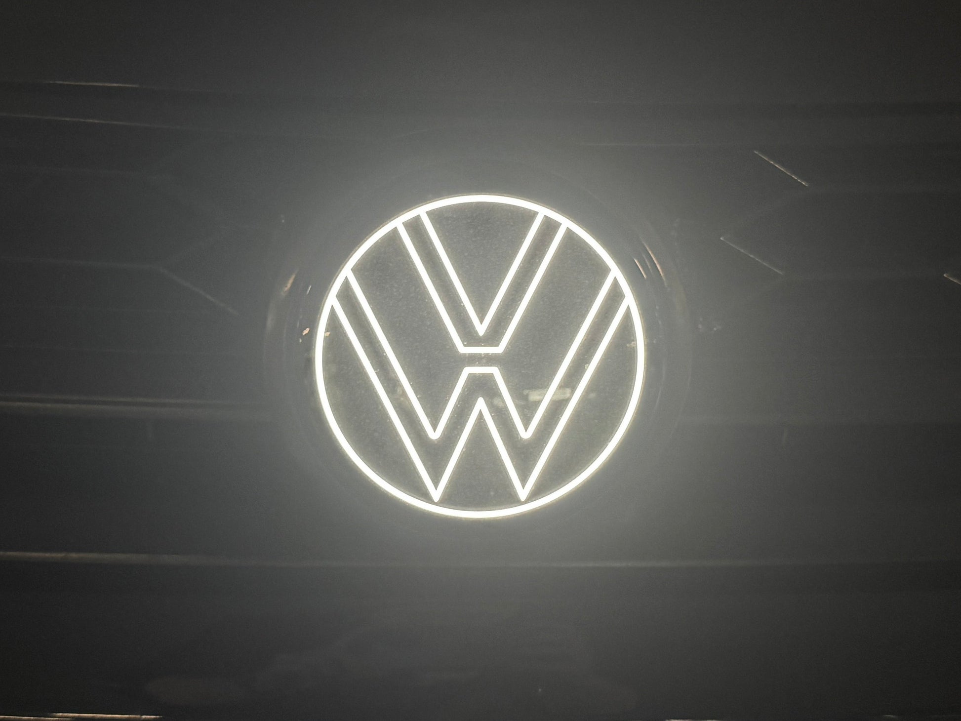 Volkswagen logo illuminated on a dark background