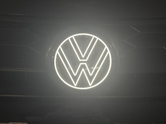 Volkswagen logo illuminated on a dark background